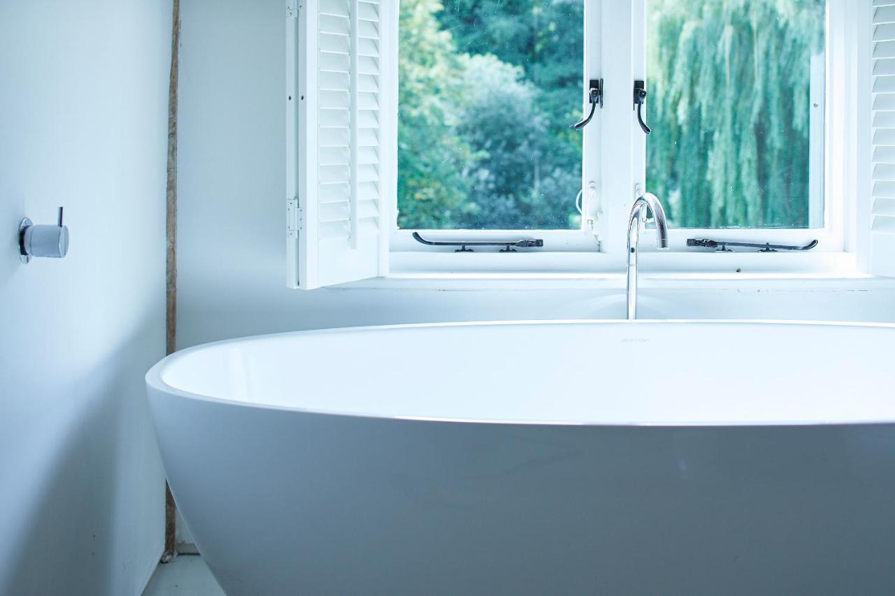 Tuddenham Mill Luxury Hotel Exterior photo A freestanding bathtub